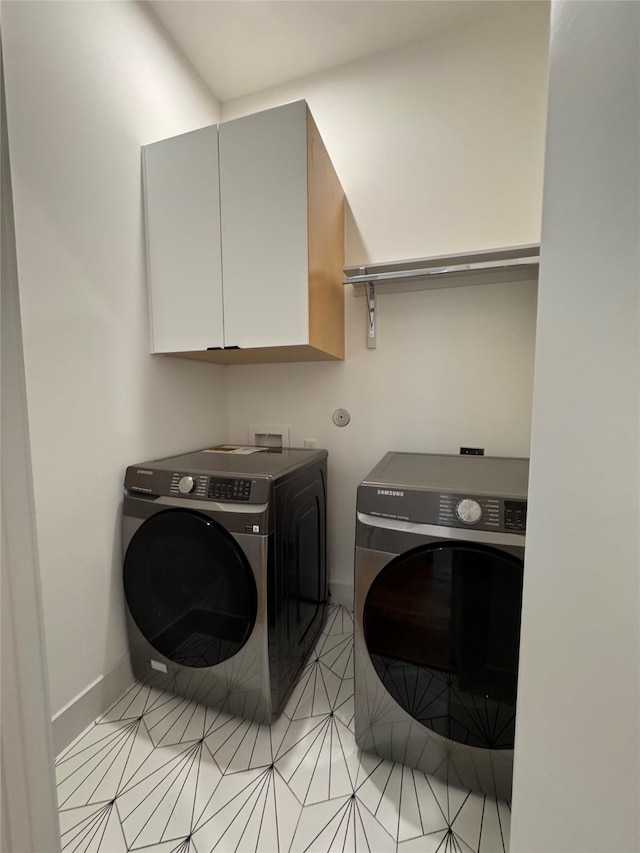 113 E 32nd St Unit A, Houston, TX 77018 - washroom featuring washing machine and clothes dryer, cabinet space, baseboards, and light tile patterned floors