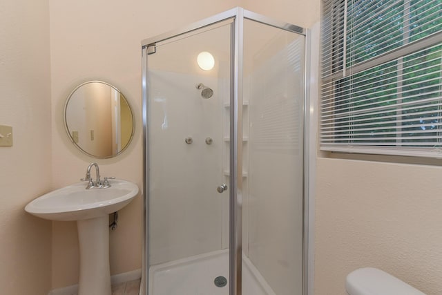 18610 Anne Dr, Webster, TX 77058 - full bathroom featuring a stall shower, toilet, and a sink