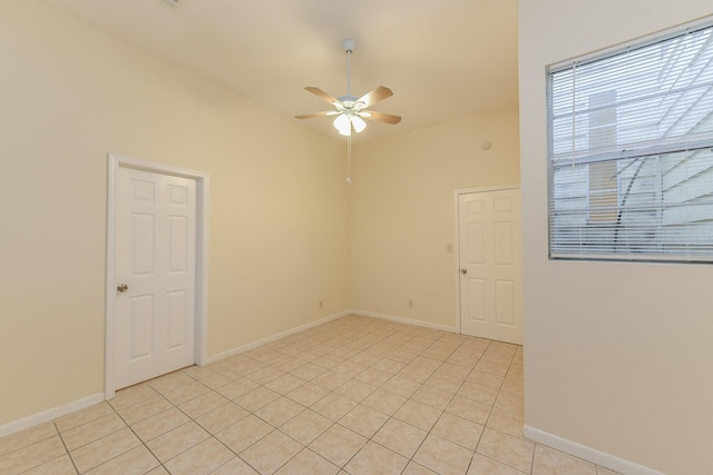 18610 Anne Dr, Webster, TX 77058 - unfurnished room featuring ceiling fan, light tile patterned floors, baseboards, and lofted ceiling
