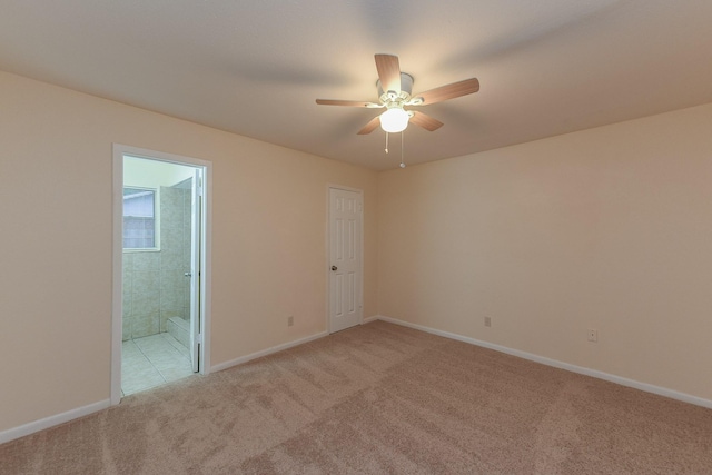 18610 Anne Dr, Webster, TX 77058 - empty room with light colored carpet, a ceiling fan, and baseboards