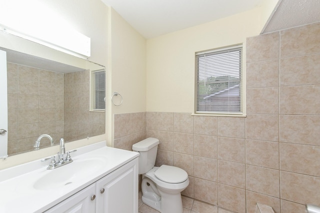 18610 Anne Dr, Webster, TX 77058 - bathroom with tile walls, toilet, vanity, tile patterned floors, and a wainscoted wall