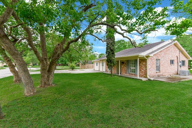 18610 Anne Dr, Webster, TX 77058 - view of front facade featuring cooling unit, brick siding, driveway, and a front yard
