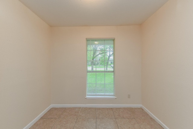 18610 Anne Dr, Webster, TX 77058 - unfurnished room with plenty of natural light, light tile patterned floors, and baseboards