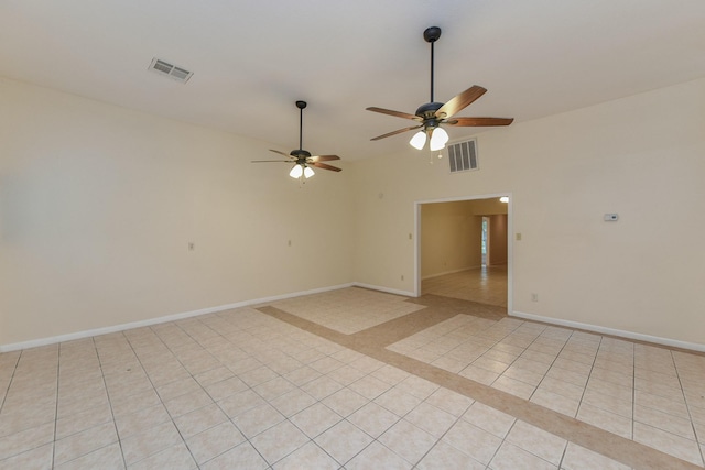 18610 Anne Dr, Webster, TX 77058 - empty room with a ceiling fan, baseboards, light tile patterned floors, and vaulted ceiling