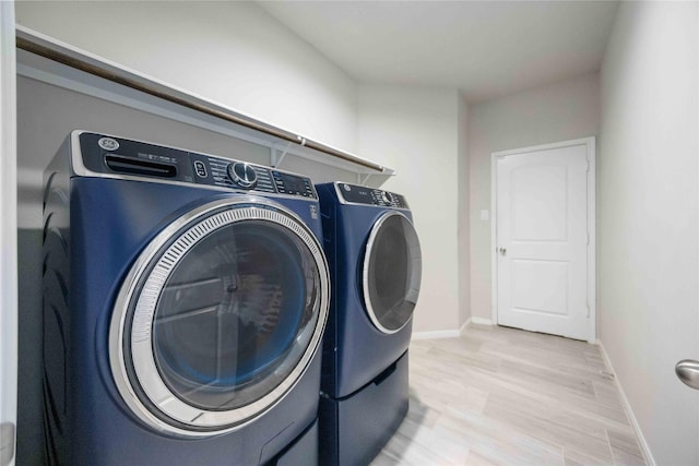 18219 Octavio Frias Trl, Houston, TX 77044 - laundry area with washer and dryer and light wood-type flooring