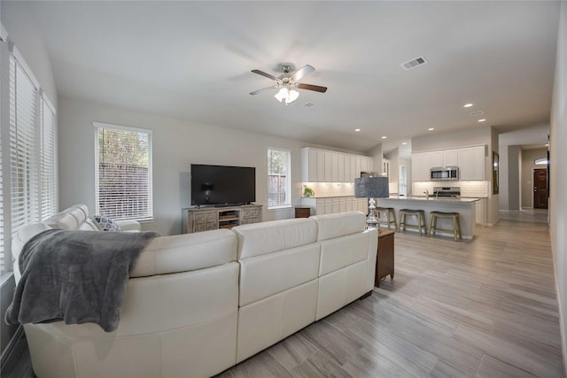 18219 Octavio Frias Trl, Houston, TX 77044 - living room with ceiling fan, plenty of natural light, recessed lighting, and light wood-style floors