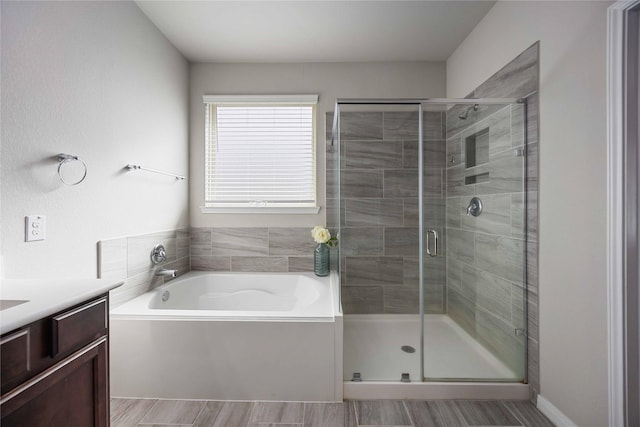 18219 Octavio Frias Trl, Houston, TX 77044 - full bathroom featuring a bath, a shower stall, and vanity
