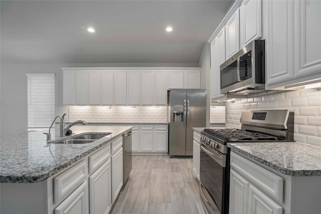 18219 Octavio Frias Trl, Houston, TX 77044 - kitchen with appliances with stainless steel finishes, white cabinetry, decorative backsplash, and recessed lighting
