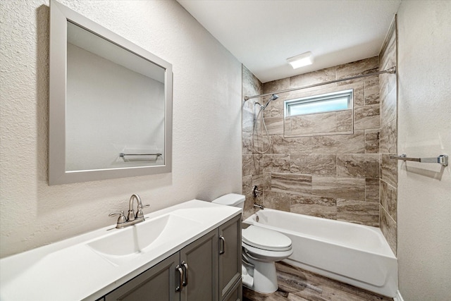 2531 Meandering Trl, Houston, TX 77339 - full bathroom with vanity, toilet, wood finished floors, shower / bathtub combination, and a textured wall