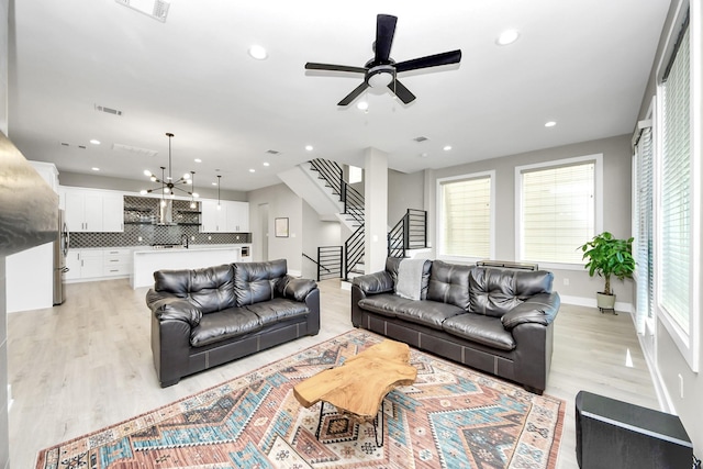 1805 Blodgett St, Houston, TX 77004 - living room featuring stairs, light wood-type flooring, ceiling fan, recessed lighting, and baseboards