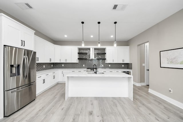 1805 Blodgett St, Houston, TX 77004 - kitchen with stainless steel refrigerator with ice dispenser, a sink, baseboards, light countertops, and backsplash