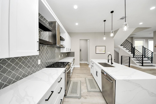 1805 Blodgett St, Houston, TX 77004 - kitchen with stainless steel appliances, a sink, light wood-type flooring, backsplash, and recessed lighting