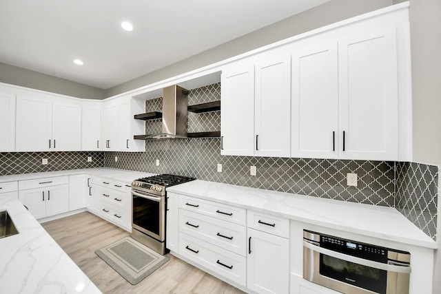 1805 Blodgett St, Houston, TX 77004 - kitchen with appliances with stainless steel finishes, open shelves, light stone countertops, wall chimney range hood, and recessed lighting
