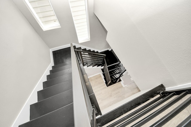 1805 Blodgett St, Houston, TX 77004 - stairs featuring wood finished floors and a skylight