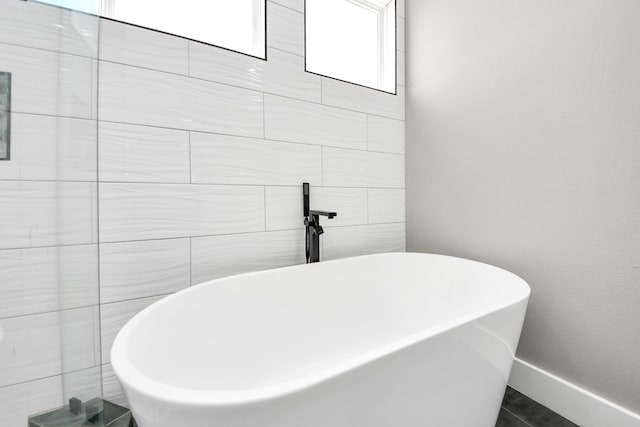 1805 Blodgett St, Houston, TX 77004 - bathroom featuring a soaking tub and baseboards