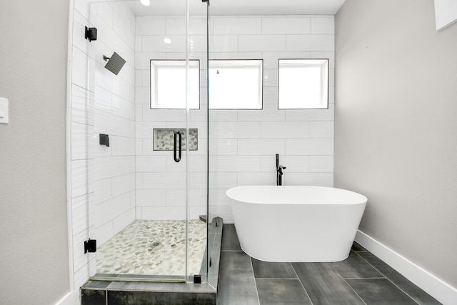 1805 Blodgett St, Houston, TX 77004 - full bath featuring a stall shower, a soaking tub, healthy amount of natural light, and tile patterned flooring