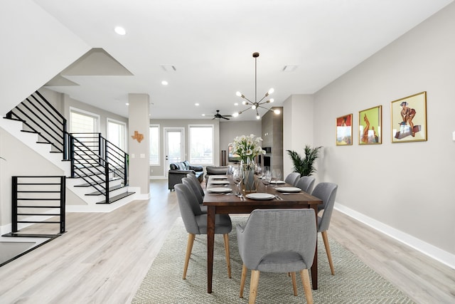 1805 Blodgett St, Houston, TX 77004 - dining space featuring light wood-type flooring, stairs, a chandelier, baseboards, and recessed lighting