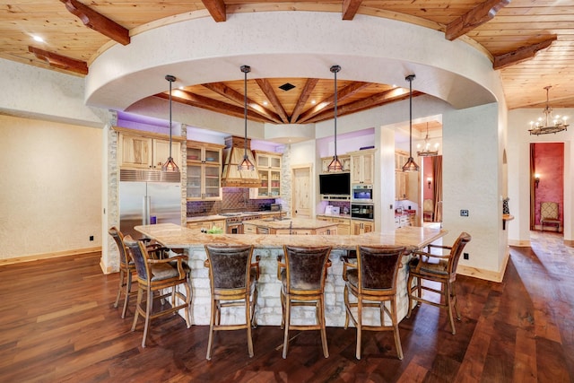 10002 Oxted Ln, Spring, TX 77379 - kitchen with high end appliances, a spacious island, a chandelier, dark wood-style flooring, and light stone counters