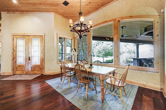 10002 Oxted Ln, Spring, TX 77379 - dining area with a chandelier, dark wood finished floors, a textured wall, baseboards, and wood ceiling