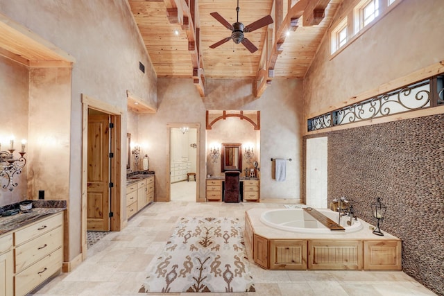10002 Oxted Ln, Spring, TX 77379 - bathroom with high vaulted ceiling, wood ceiling with exposed beams, ceiling fan, a bath, and vanity