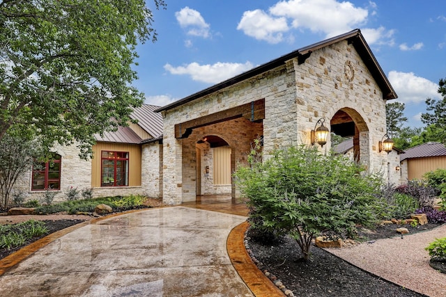 10002 Oxted Ln, Spring, TX 77379 - view of front facade featuring stone siding and a standing seam roof