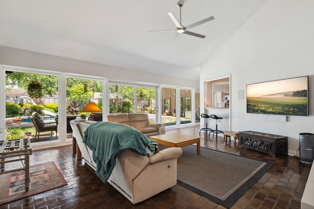 10318 Pine Forest Rd, Houston, TX 77042 - living area featuring healthy amount of natural light, ceiling fan, high vaulted ceiling, and brick flooring