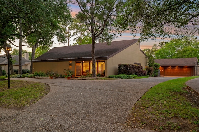 10318 Pine Forest Rd, Houston, TX 77042 - mid-century modern home with asphalt driveway and stucco siding
