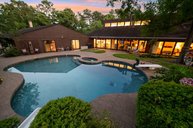 10318 Pine Forest Rd, Houston, TX 77042 - view of swimming pool with a patio, a diving board, and a pool with connected hot tub