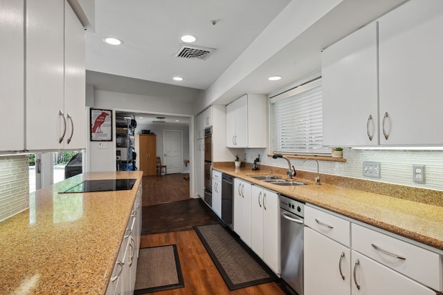 10318 Pine Forest Rd, Houston, TX 77042 - kitchen featuring black electric stovetop, recessed lighting, dark wood finished floors, white cabinetry, and a sink