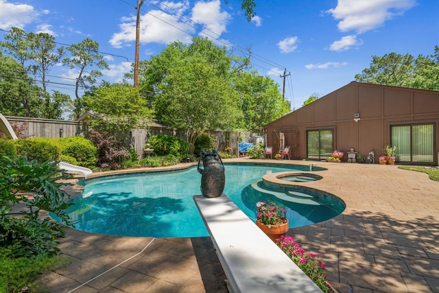 10318 Pine Forest Rd, Houston, TX 77042 - view of swimming pool with a jacuzzi, a fenced backyard, a patio area, a water slide, and a diving board