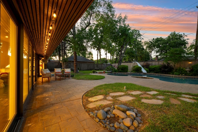 10318 Pine Forest Rd, Houston, TX 77042 - yard at dusk featuring a fenced backyard and a patio