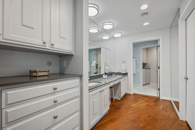10318 Pine Forest Rd, Houston, TX 77042 - full bathroom featuring double vanity, baseboards, wood finished floors, and recessed lighting