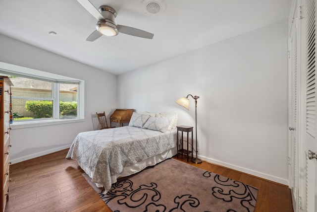 10318 Pine Forest Rd, Houston, TX 77042 - bedroom with baseboards, wood finished floors, and a ceiling fan