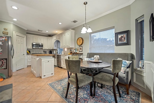 9203 Baber Run Cir, Houston, TX 77095 - dining room featuring crown molding, light tile patterned flooring, recessed lighting, and a chandelier
