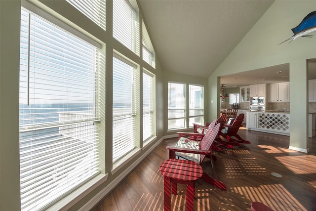 131 Isles End Rd, Tiki Island, TX 77554 - sunroom with healthy amount of natural light, high vaulted ceiling, baseboards, and wood finished floors