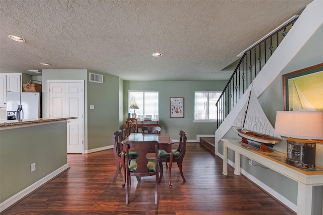 131 Isles End Rd, Tiki Island, TX 77554 - dining area featuring a textured ceiling, stairs, dark wood-style floors, baseboards, and recessed lighting