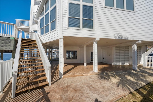 131 Isles End Rd, Tiki Island, TX 77554 - view of side of home featuring a carport, stairway, driveway, and a wooden deck