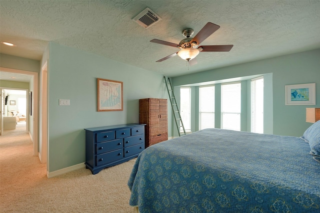 131 Isles End Rd, Tiki Island, TX 77554 - bedroom with light carpet, a textured ceiling, a ceiling fan, and baseboards
