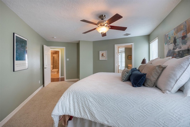 131 Isles End Rd, Tiki Island, TX 77554 - bedroom with baseboards, carpet, ensuite bath, and ceiling fan