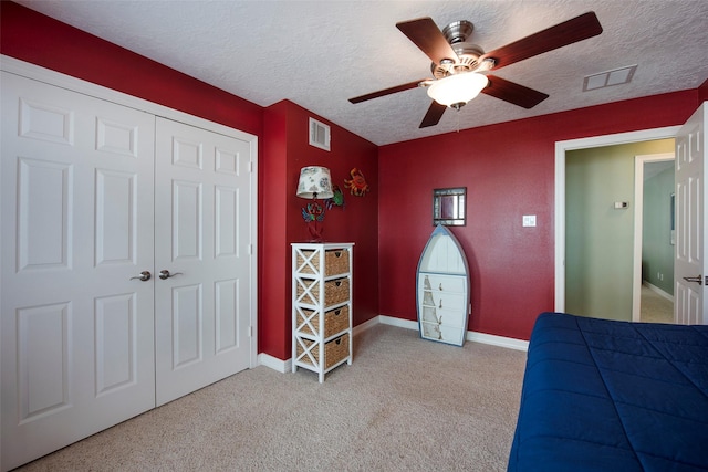 131 Isles End Rd, Tiki Island, TX 77554 - carpeted bedroom with a textured ceiling, a ceiling fan, a closet, and baseboards