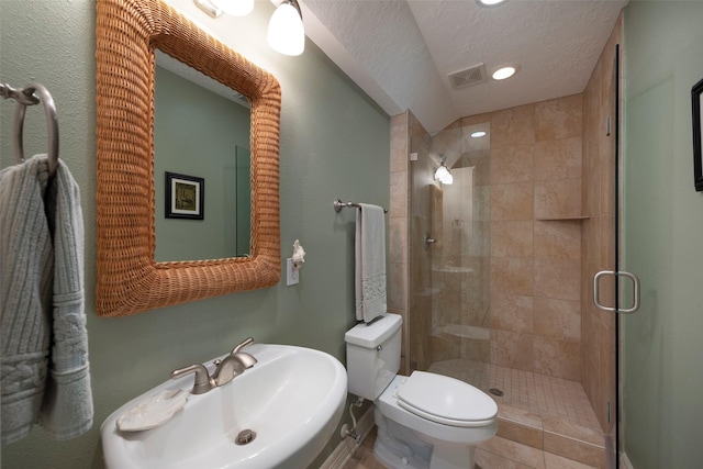 131 Isles End Rd, Tiki Island, TX 77554 - bathroom featuring toilet, a shower stall, a sink, a textured ceiling, and recessed lighting