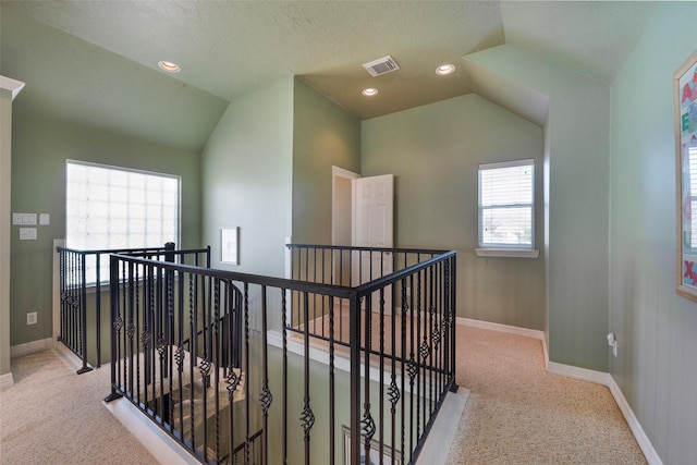 131 Isles End Rd, Tiki Island, TX 77554 - hall featuring an upstairs landing, vaulted ceiling, carpet floors, and baseboards