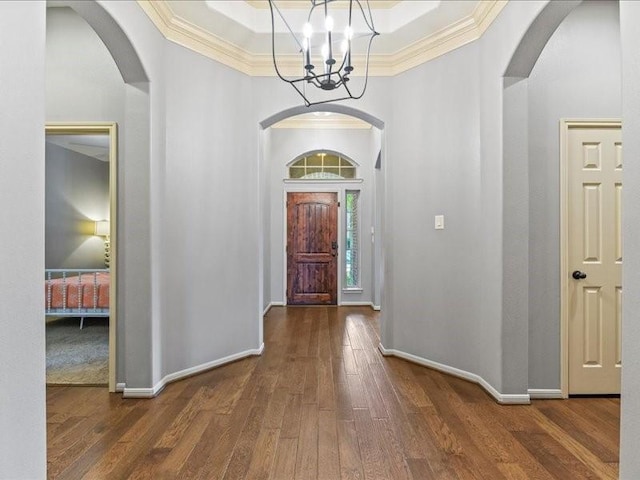 17806 Creek Bluff Ln, Cypress, TX 77433 - foyer entrance with a chandelier, ornamental molding, wood finished floors, a tray ceiling, and a high ceiling