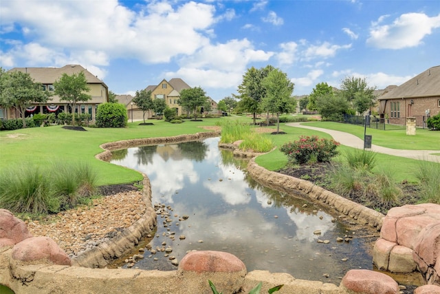 17806 Creek Bluff Ln, Cypress, TX 77433 - surrounding community with a lawn, a water view, and a residential view