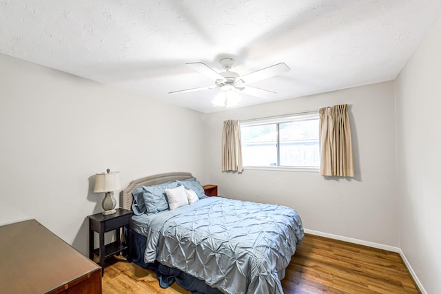 6902 Wagonwheel Ln, Houston, TX 77088 - bedroom featuring wood finished floors, baseboards, and ceiling fan