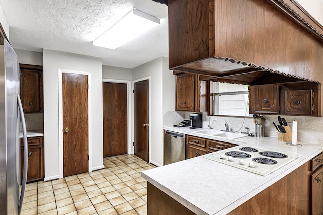 6902 Wagonwheel Ln, Houston, TX 77088 - kitchen featuring stainless steel appliances, light countertops, a sink, and a peninsula