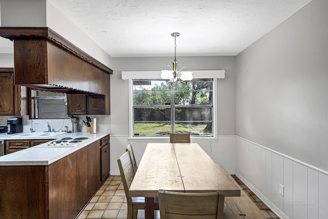 6902 Wagonwheel Ln, Houston, TX 77088 - dining space featuring a chandelier and a wainscoted wall