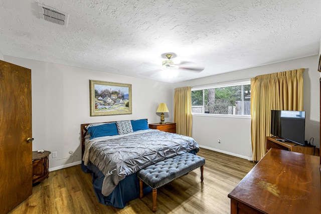 6902 Wagonwheel Ln, Houston, TX 77088 - bedroom with wood finished floors, a textured ceiling, baseboards, and ceiling fan