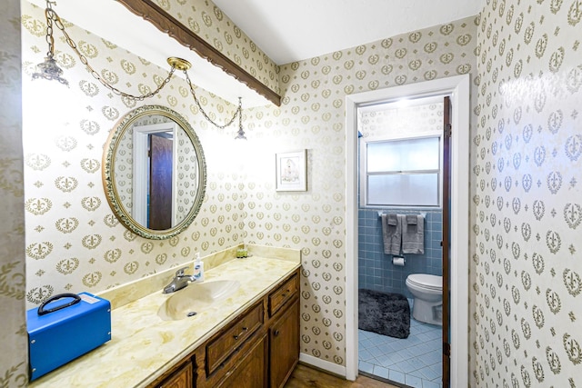6902 Wagonwheel Ln, Houston, TX 77088 - bathroom with vanity, toilet, wallpapered walls, and tile patterned floors