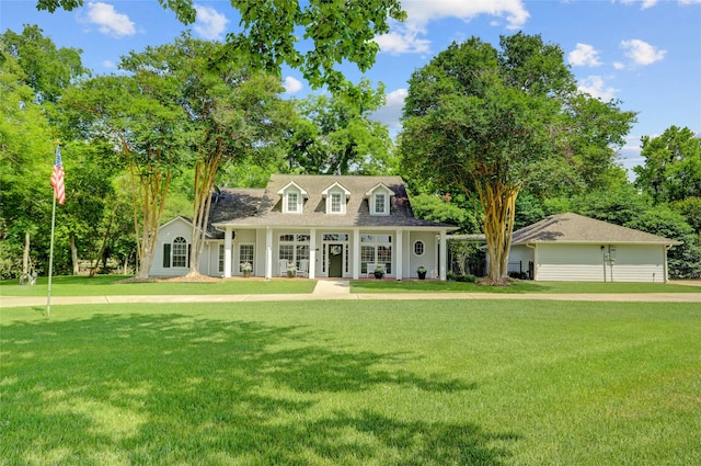 3350 Precinct Line Rd, Richmond, TX 77406 - cape cod home with covered porch, a front lawn, and view of wooded area